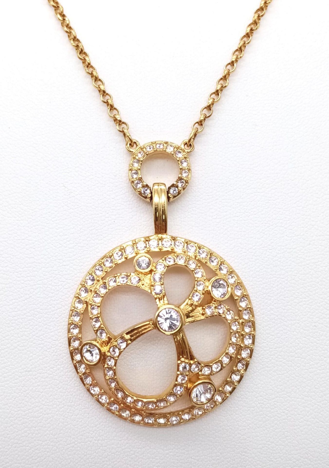 A Swarovski Gilded Necklace and Pendant with White Stone Decoration.