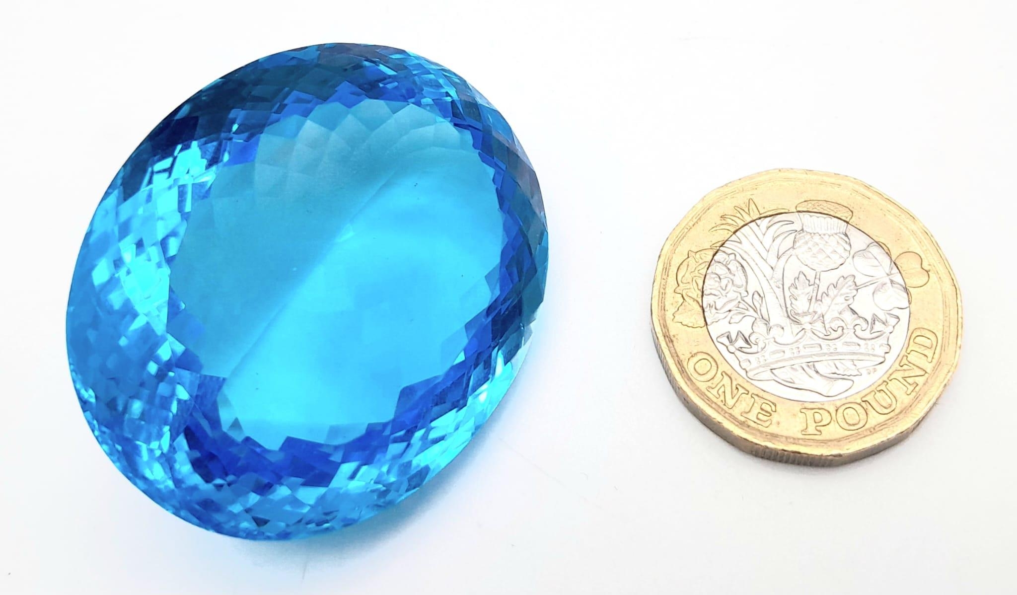A large (162.81 carats), oval cut natural topaz, with vivid sky blue uniform colouration, - Image 3 of 4