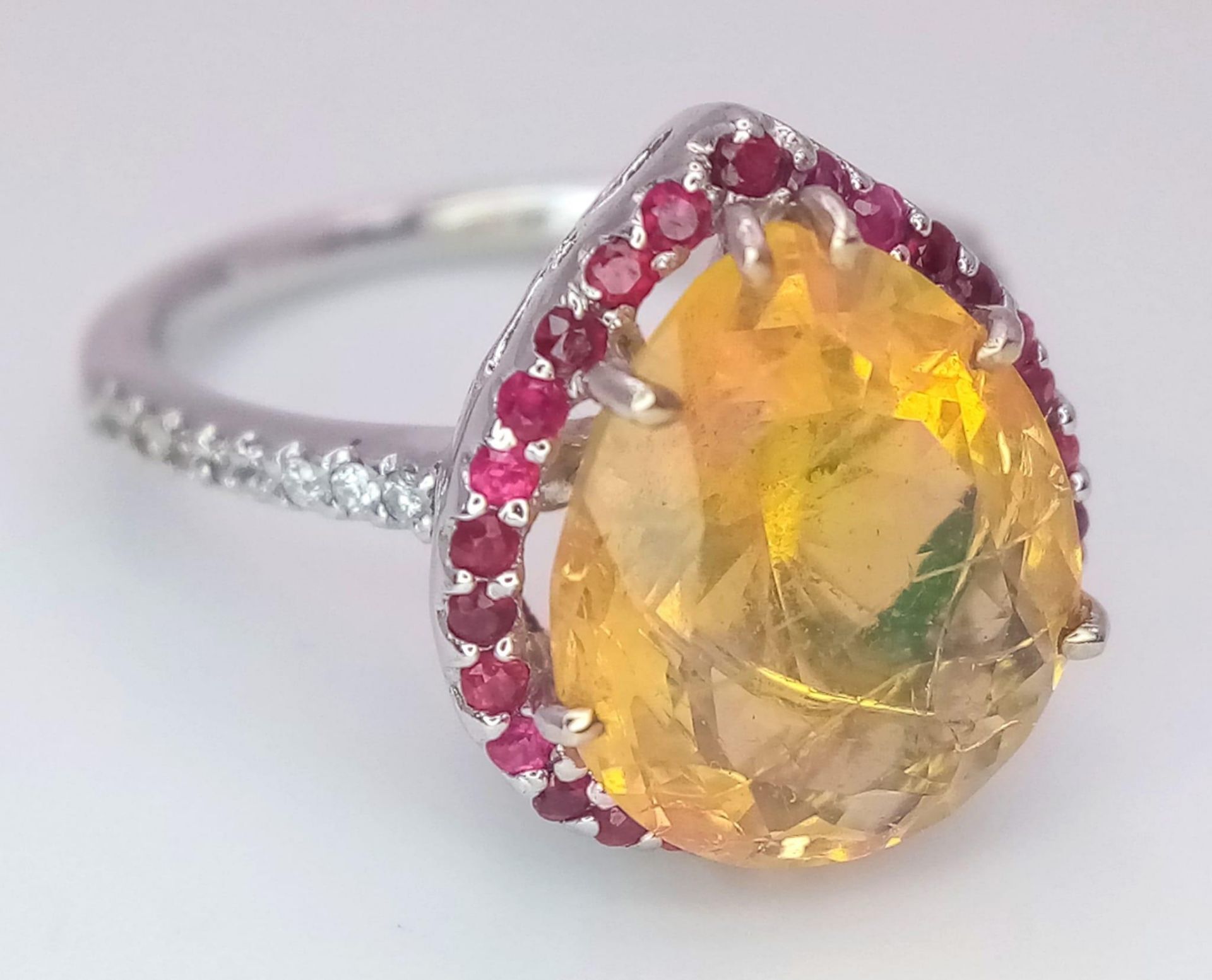 An 18 K white gold ring with a large, pear cut, fire opal exhibiting orange and green hues, - Image 7 of 9