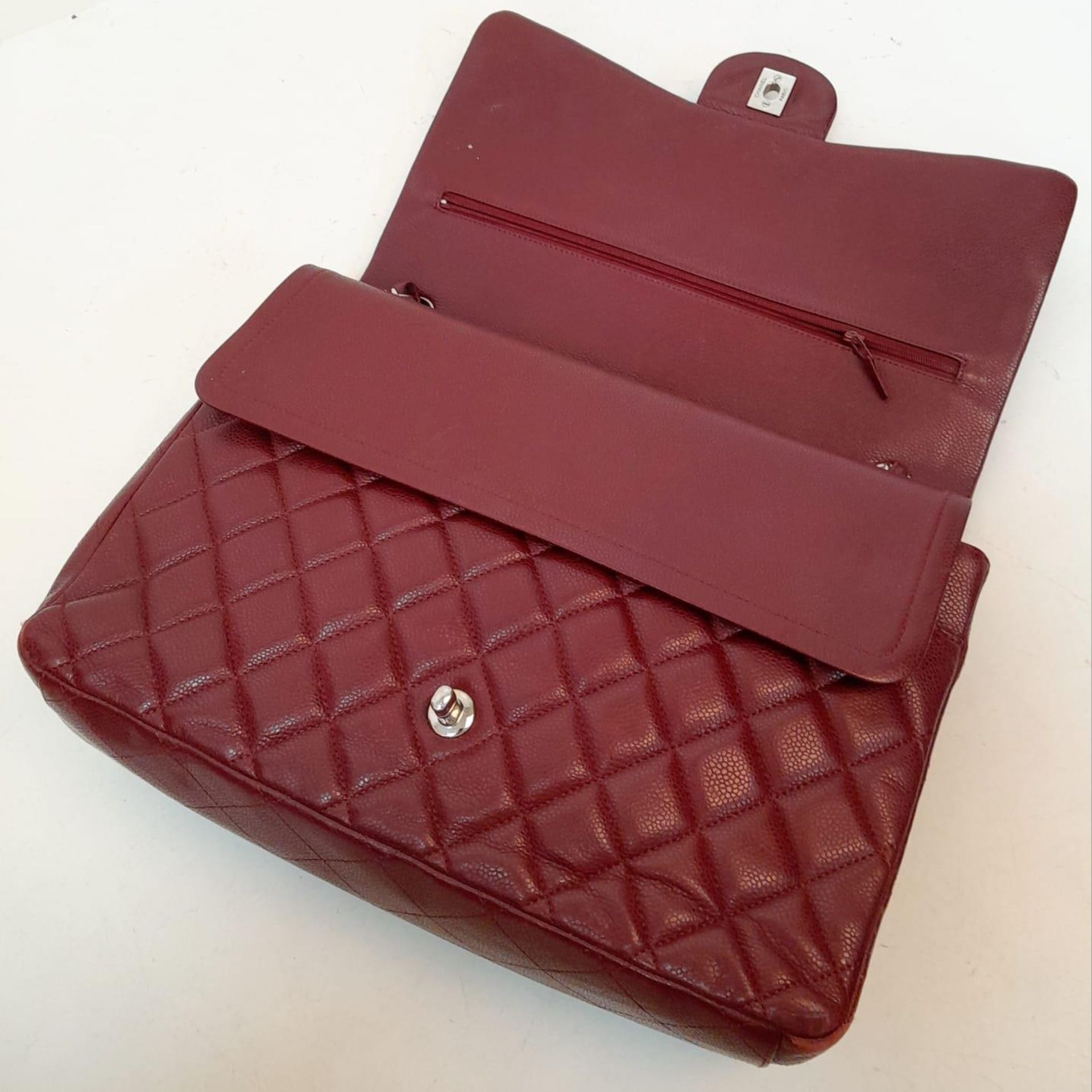 A Chanel Burgundy Jumbo Classic Double Flap Bag. Quilted leather exterior with silver-toned - Bild 13 aus 16