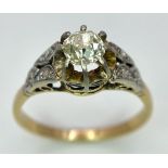 An Antique 18K Gold, Platinum and Diamond Ring. Central 0.75ct central stone with diamond accents on