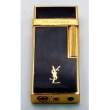 A very elegant Yves Saint Laurent gold plated and black enamelled lighter, dimensions: 63 x 26 x