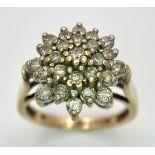 A 9K GOLD DIAMOND CLUSTER RING . 5gms size O