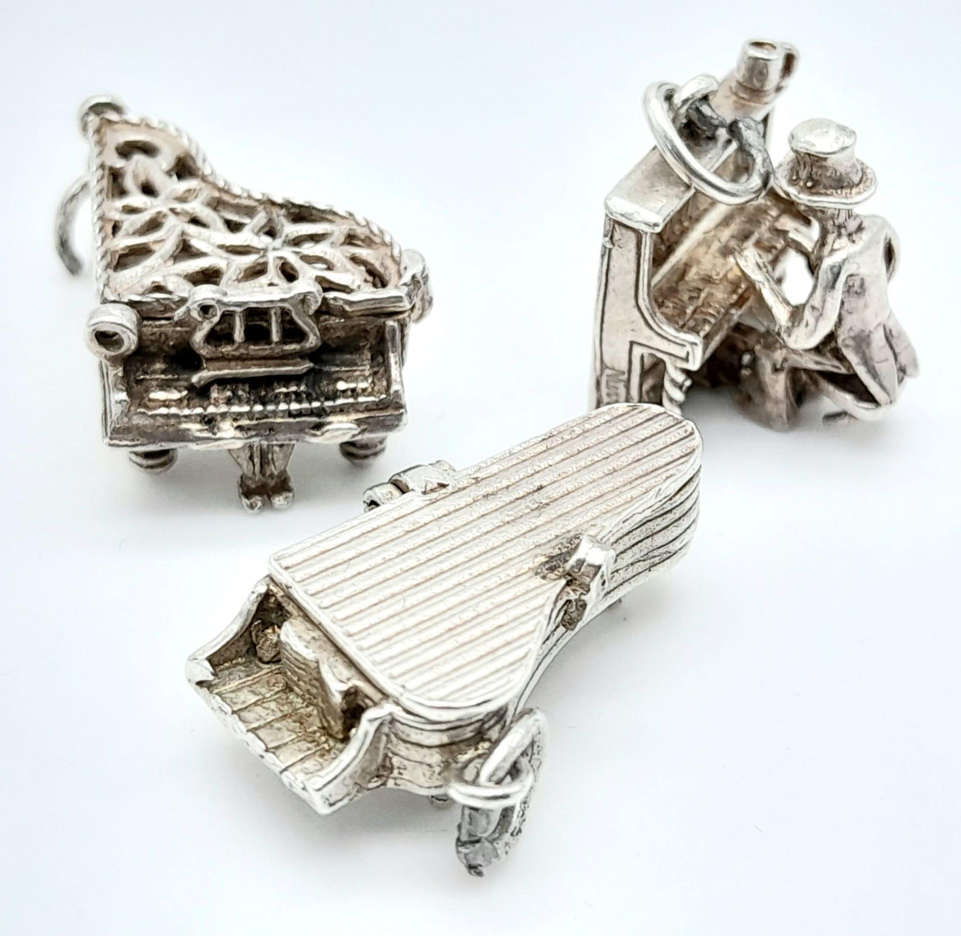 A collection of 3 vintage silver piano motif articulated charms/pendants. Total weight 12.5G