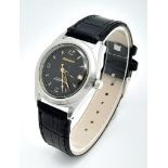 A Vintage Genicko Gents Mechanical Watch. Black leather strap. Stainless steel case - 36mm. Black