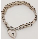 A vintage sterling silver bar gate link bracelet with heart padlock. Full hallmarks London, 1979.