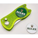 A Rolex Branded Golf Putting Green Divot Repair Tool with Removable Rolex Branded Ball Markers.