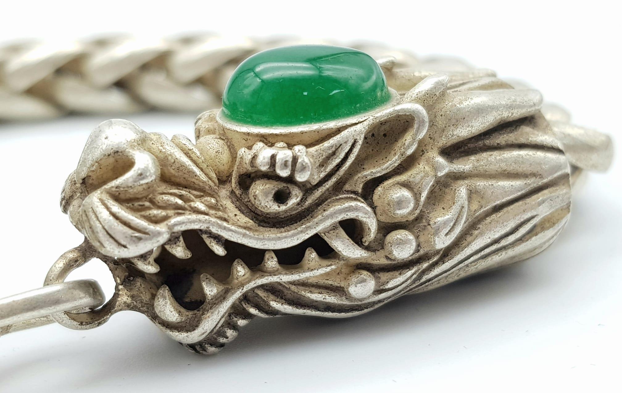 A Tibetan Silver and Green Jade Double Dragon Bracelet. Chinese dragon heads with jade cabochon - Image 2 of 5