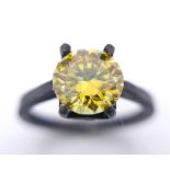 A sterling silver, with a black patina, solitaire ring with a round cut, yellow moissanite (2