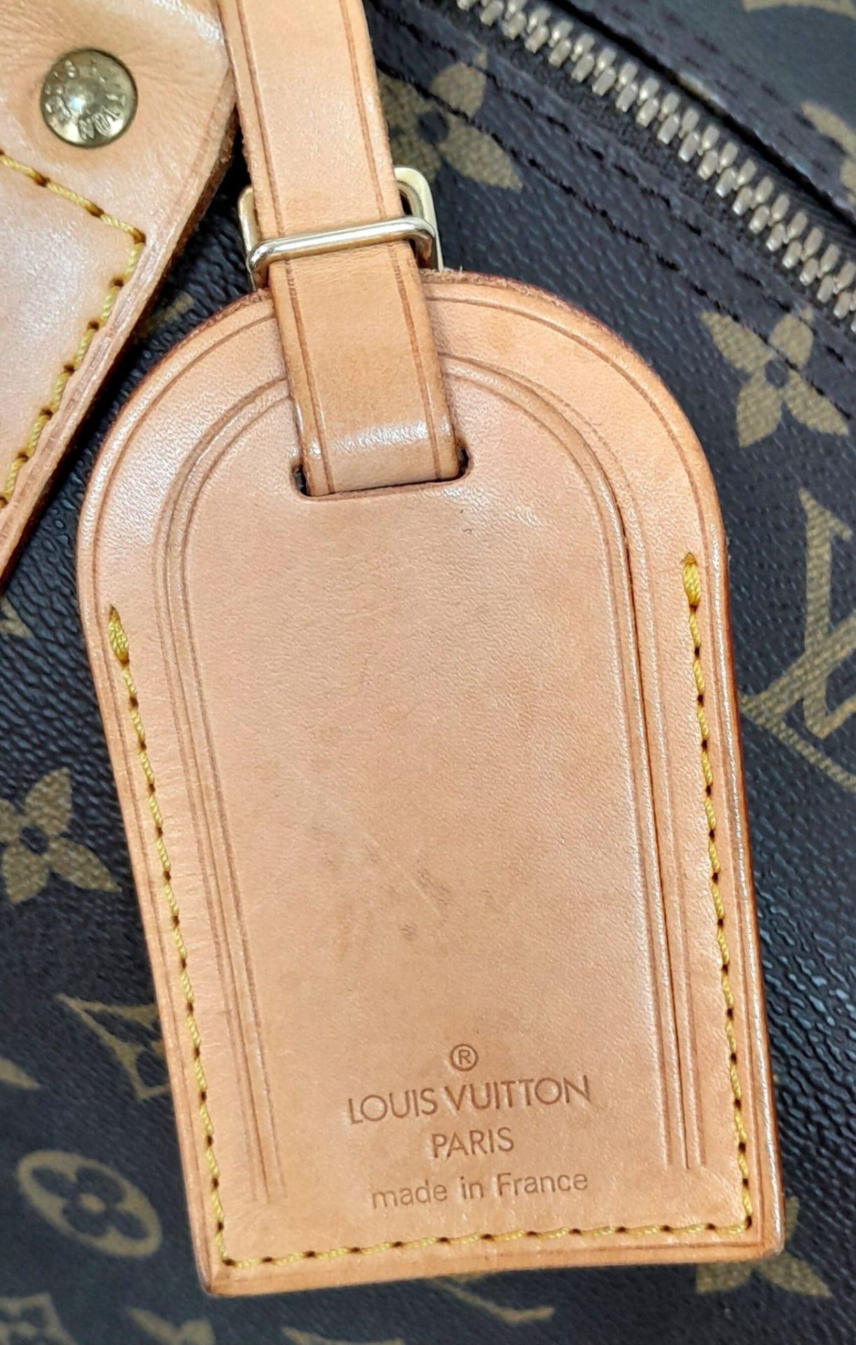 A Louis Vuitton Monogram Keepall 60 Travel Bag. Leather exterior with gold-toned hardware, two - Image 12 of 12