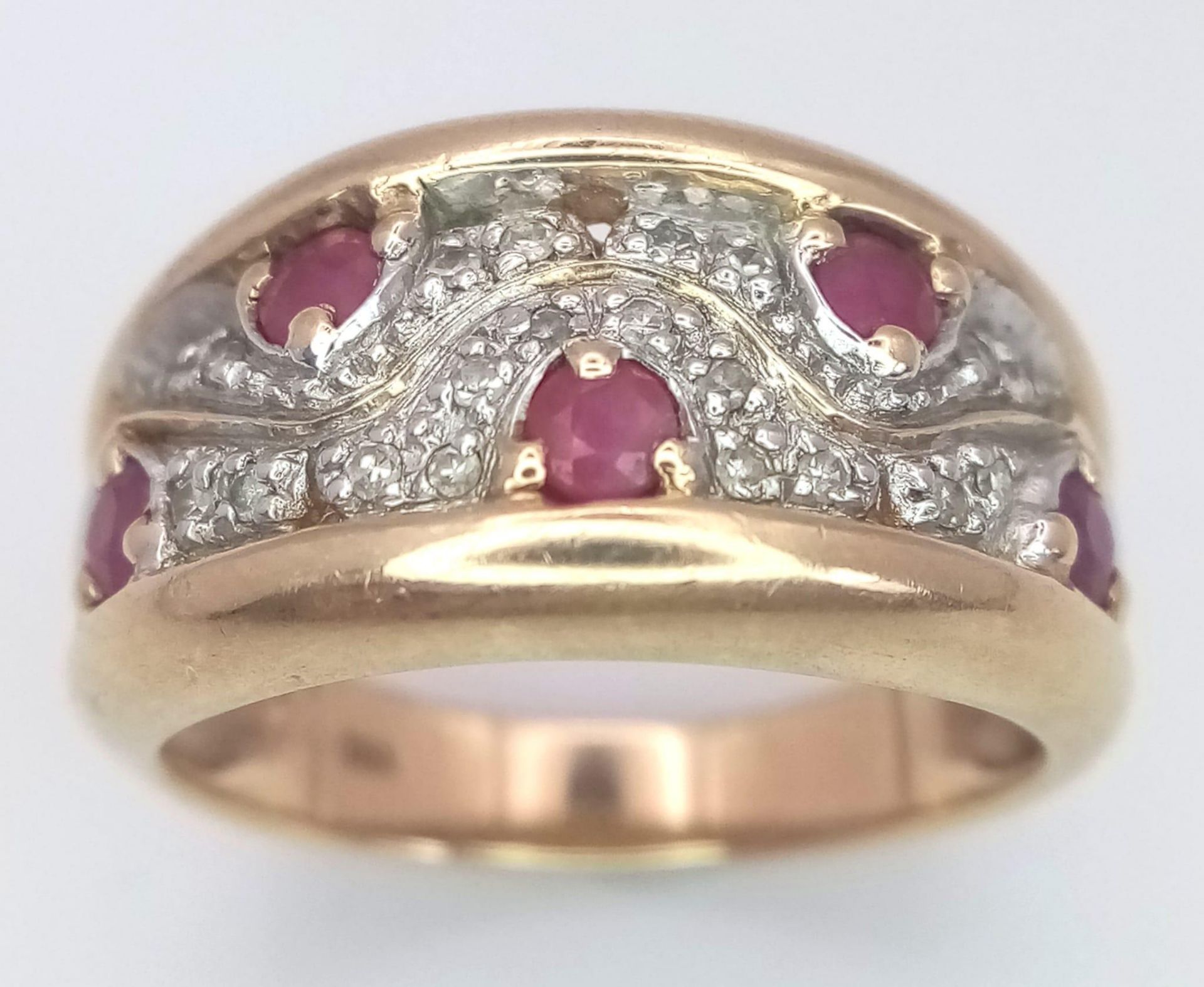 A 9K Yellow Gold Diamond and Ruby Ring. Size N, 4.8g total weight. Ref: SC 7064