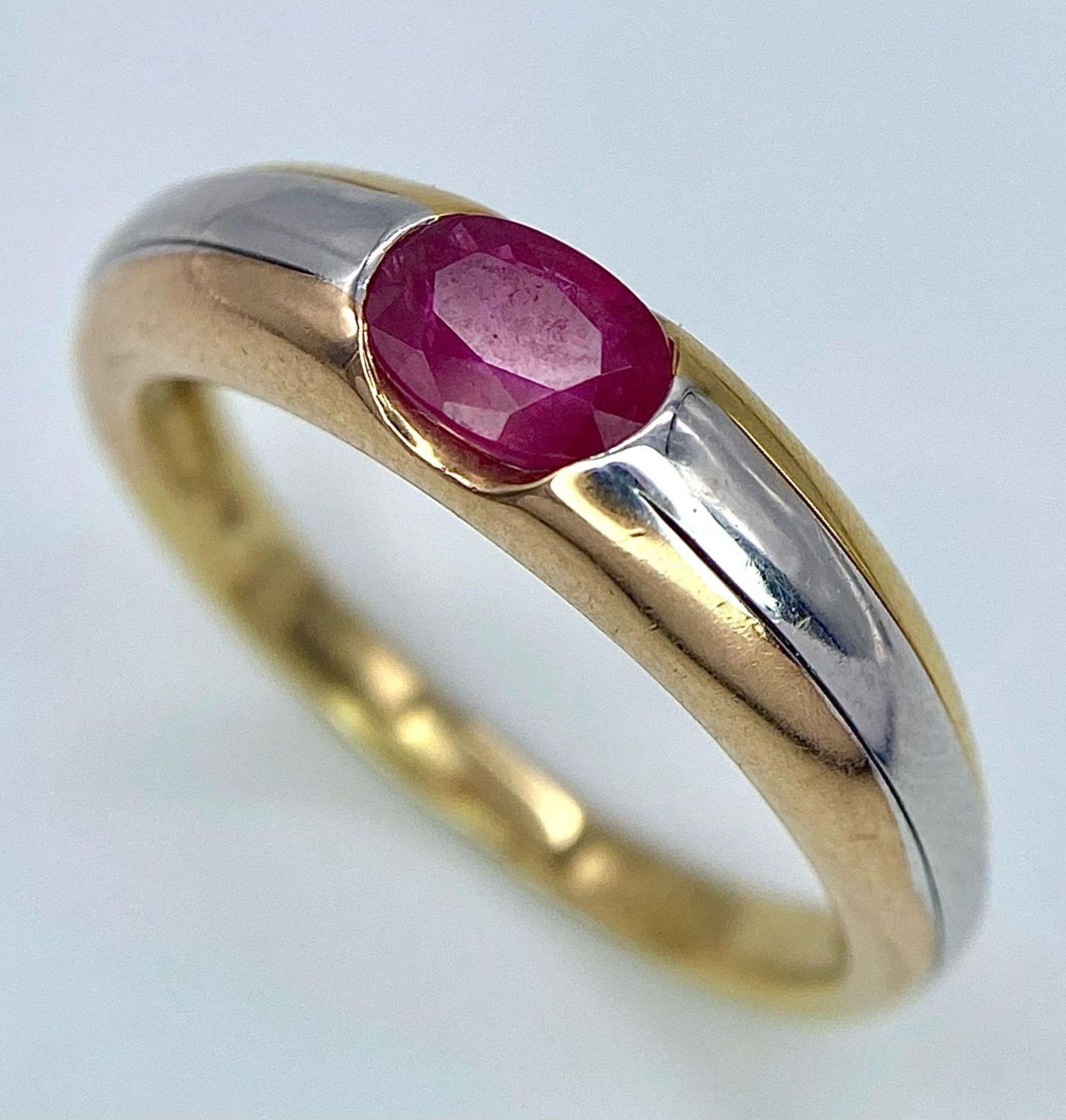 A 9K Yellow Gold Ruby Ring. Oval central ruby. Size N. 2.85g total weight. - Image 2 of 8