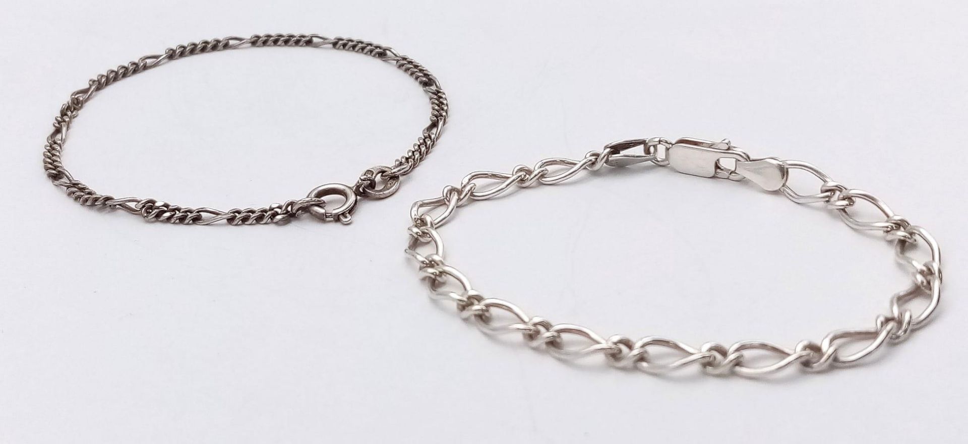 2X stylish 925 silver curb and figaro link bracelets. Total weight 7.5G. Total length 17cm and 18cm.