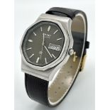 A Vintage Seiko Quartz Watch. Black leather strap. Octagonal case - 36mm. Grey dial with day/date