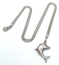 A vintage sterling silver dolphin pendant on silver curb chain. Total weight 4.2G. Total length
