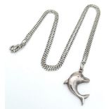 A vintage sterling silver dolphin pendant on silver curb chain. Total weight 4.2G. Total length