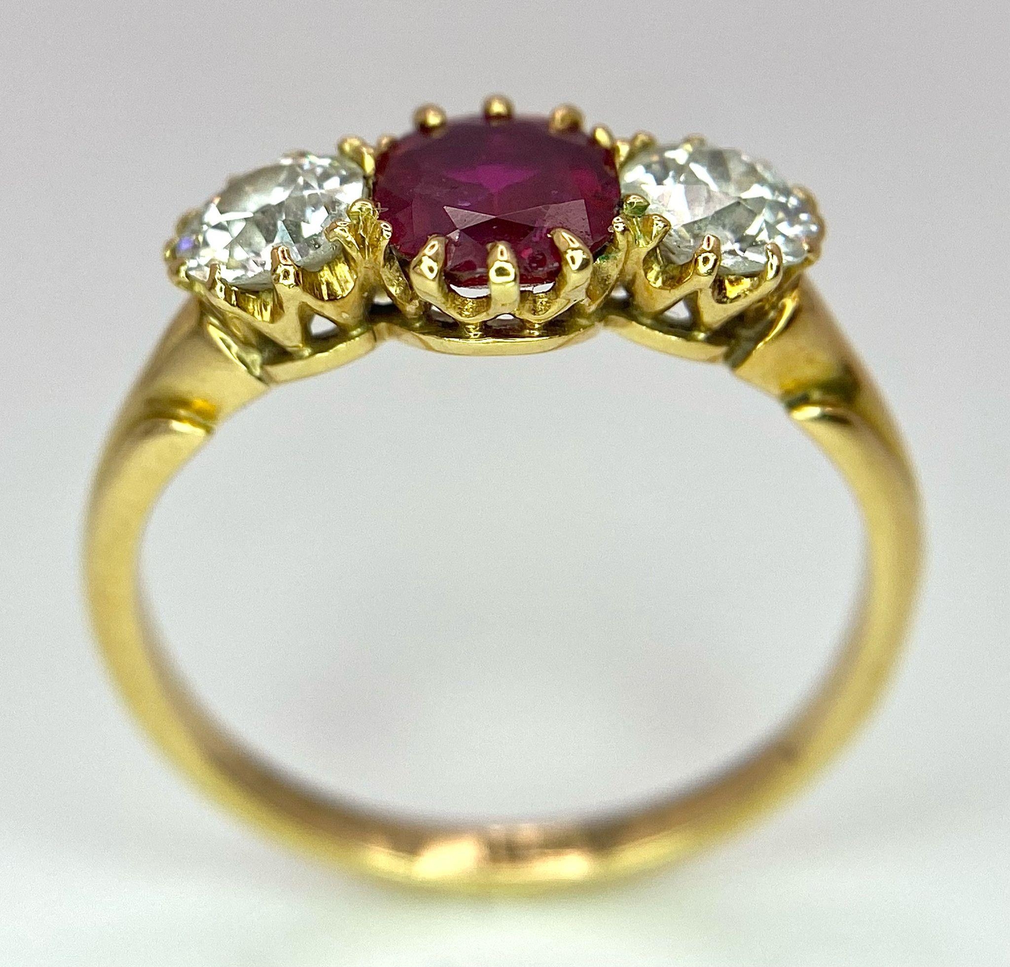 A Mesmerising 18K Yellow Gold, Ruby and Diamond Ring. A deep red oval cut ruby sits central - Image 6 of 9