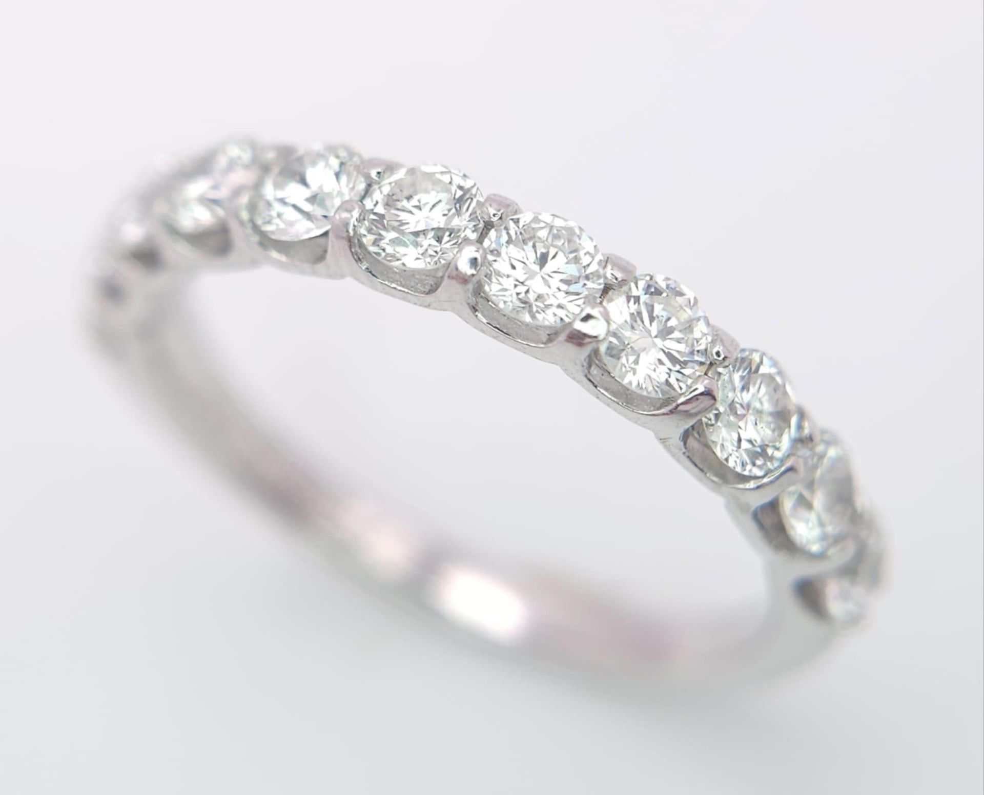 An 18 K white gold half eternity ring with good quality brilliant cut diamonds. Size: O, weight: 2.9