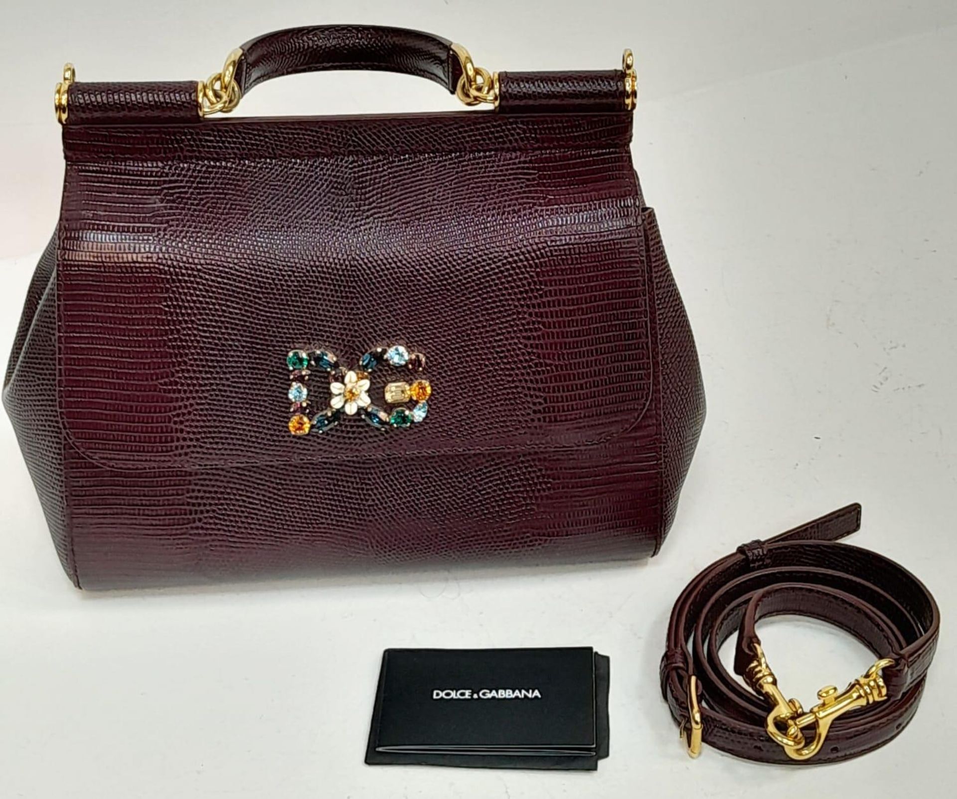 A Dolce & Gabbana Burgundy Miss Sicily Bag. Reptile embossed leather exterior with gold-toned
