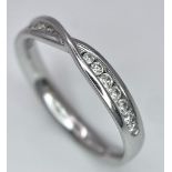 18K WHITE GOLD DIAMOND SET CROSSOVER RING - 0.20CTW. 2.9G. SIZE N.