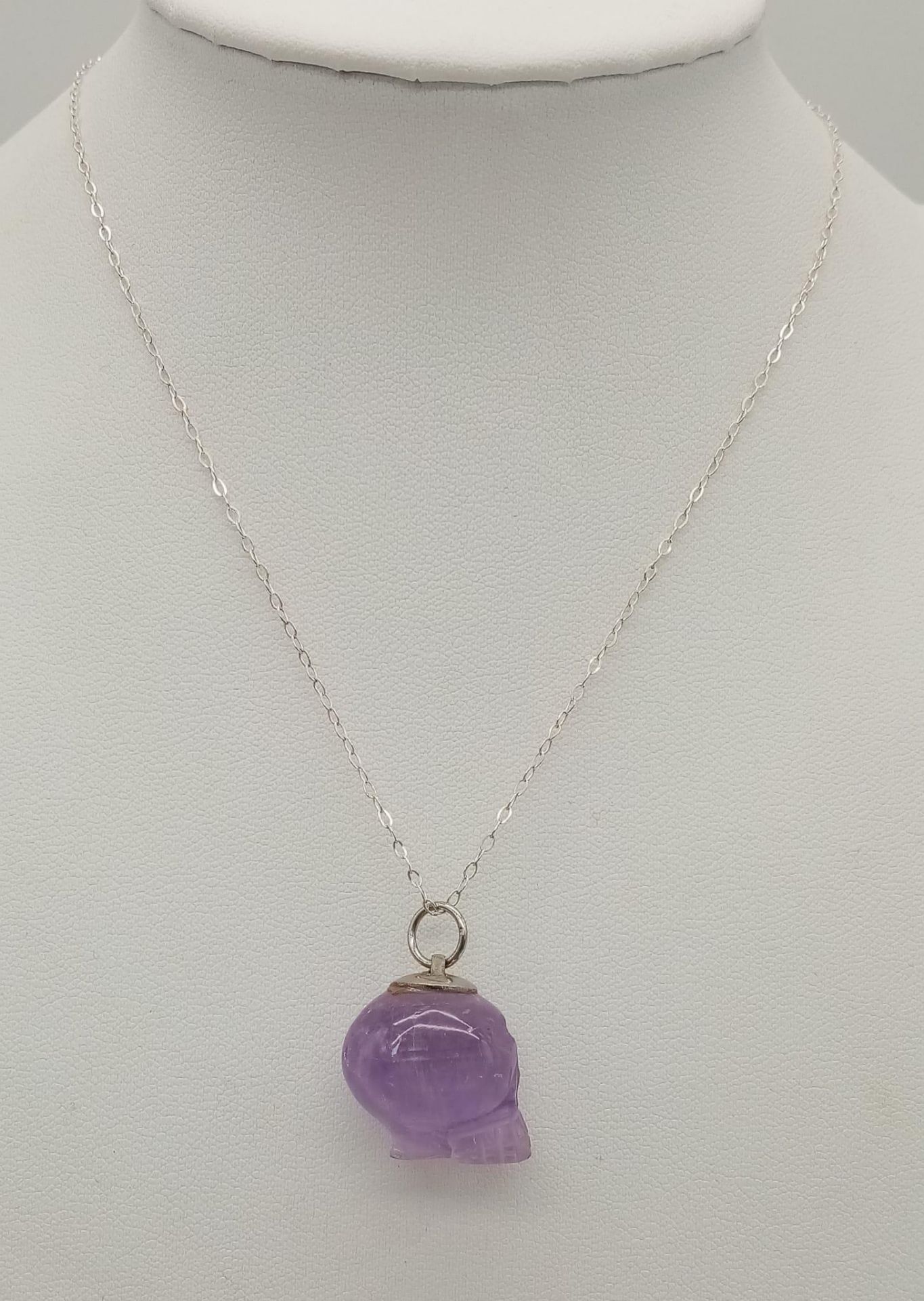 A Sterling Silver Carved Amethyst Skull Pendant Necklace. 42cm Length. Pendant Measures 2cm