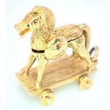 A 9K Yellow Gold Hobby Horse Charm. Opens to reveal soldiers. 2.4cm x 2.3cm, 5.8g total weight. Ref: