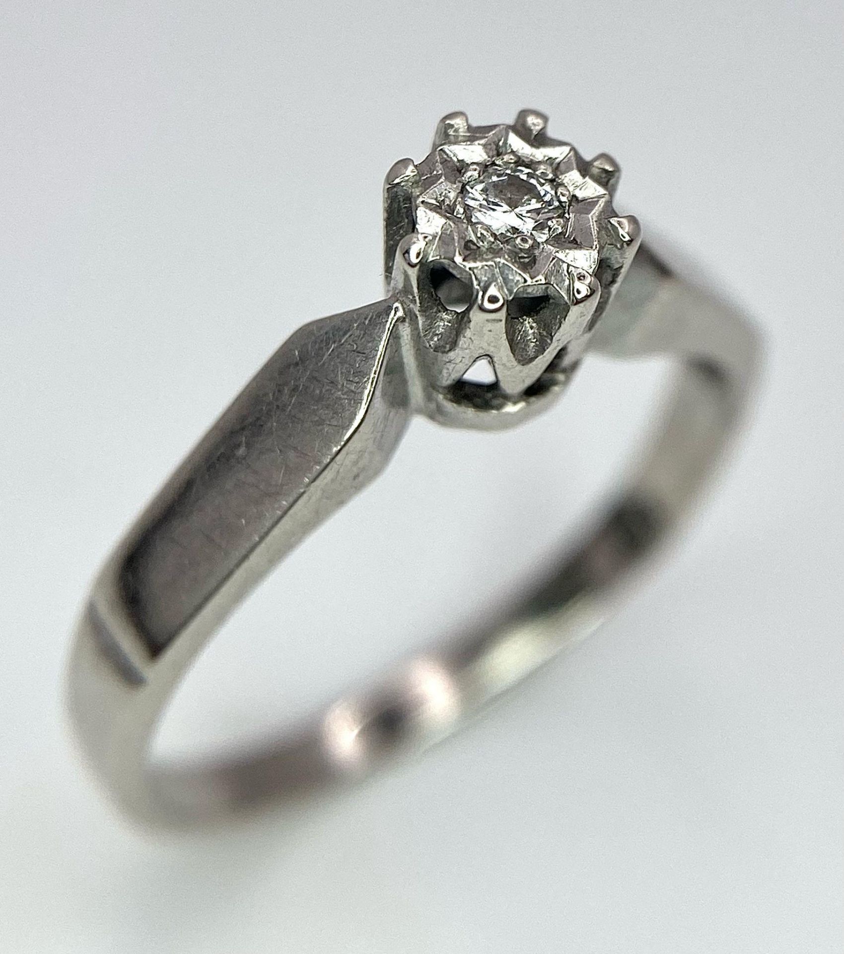 An 18K White Gold Diamond Solitaire Ring. Size M. 2.61g