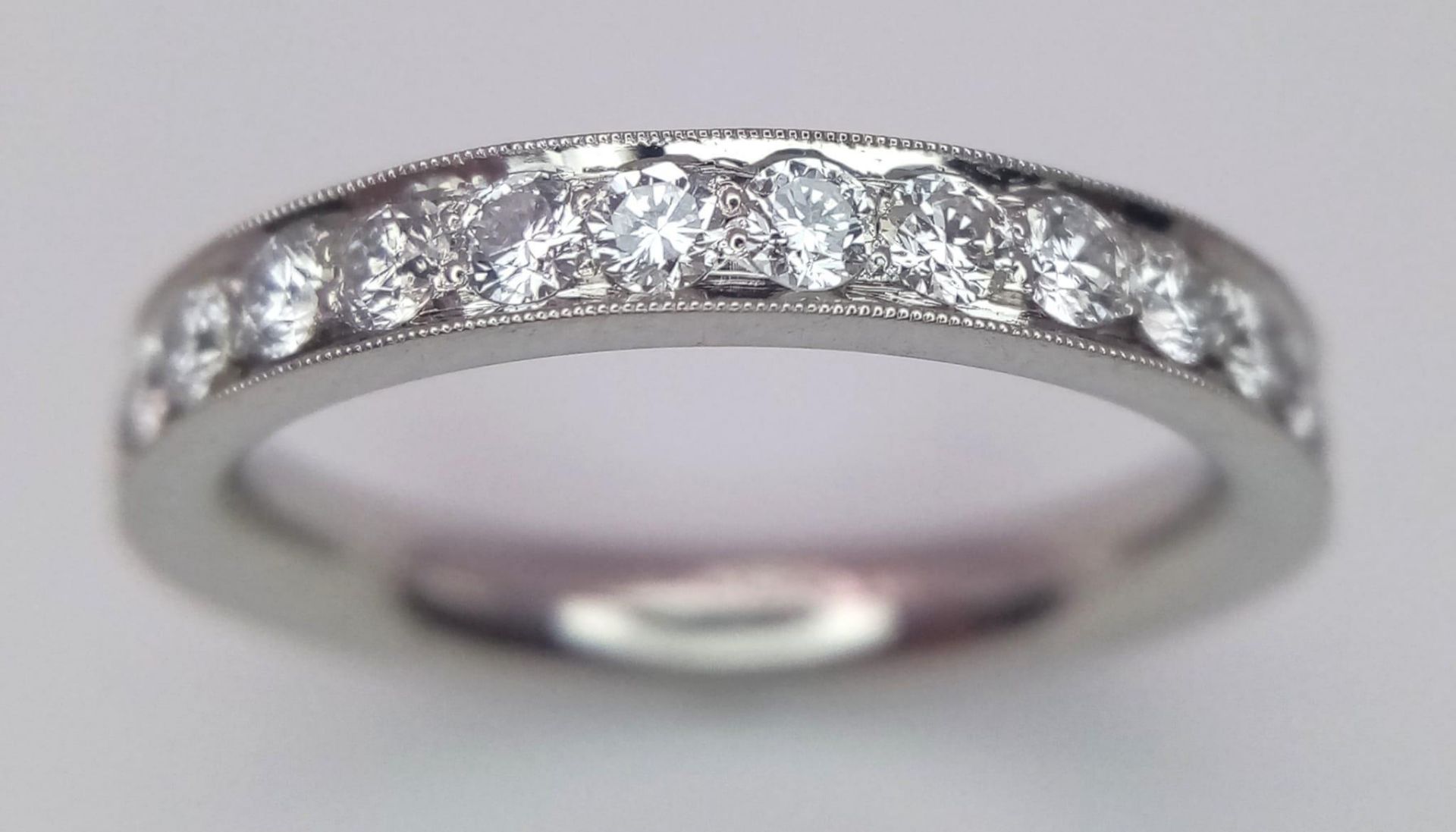 A PLATINUM AND DIAMOND BAND RING. 0.60CT. 6G. SIZE K 1/2.