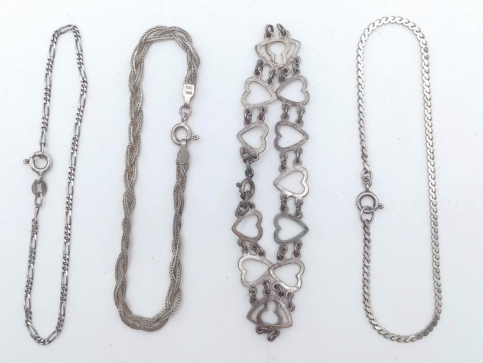 A collection of 4 stylist sterling silver bracelets include a figaro link, twisted, heart link and - Image 3 of 13