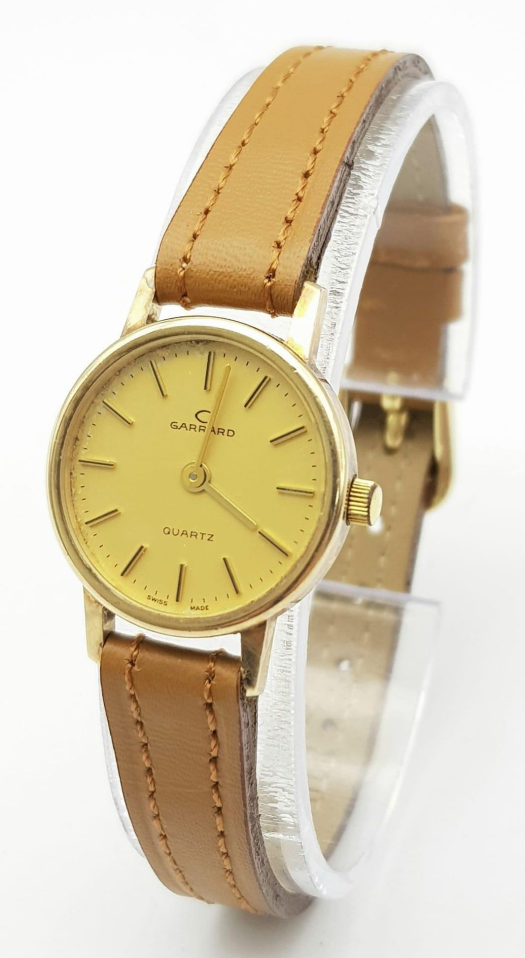 A Garrard 9K Gold Cased Quartz Ladies Watch. New brown leather strap. 9k gold case - 22mm. Gold tone