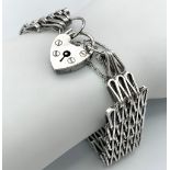 A vintage sterling silver bar gate link bracelet with hear locket. Full hallmarks London, 1976.