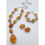 An Amber Resin Cabochon Jewellery Suite: A pair of earrings, bracelet and necklace - 56cm.