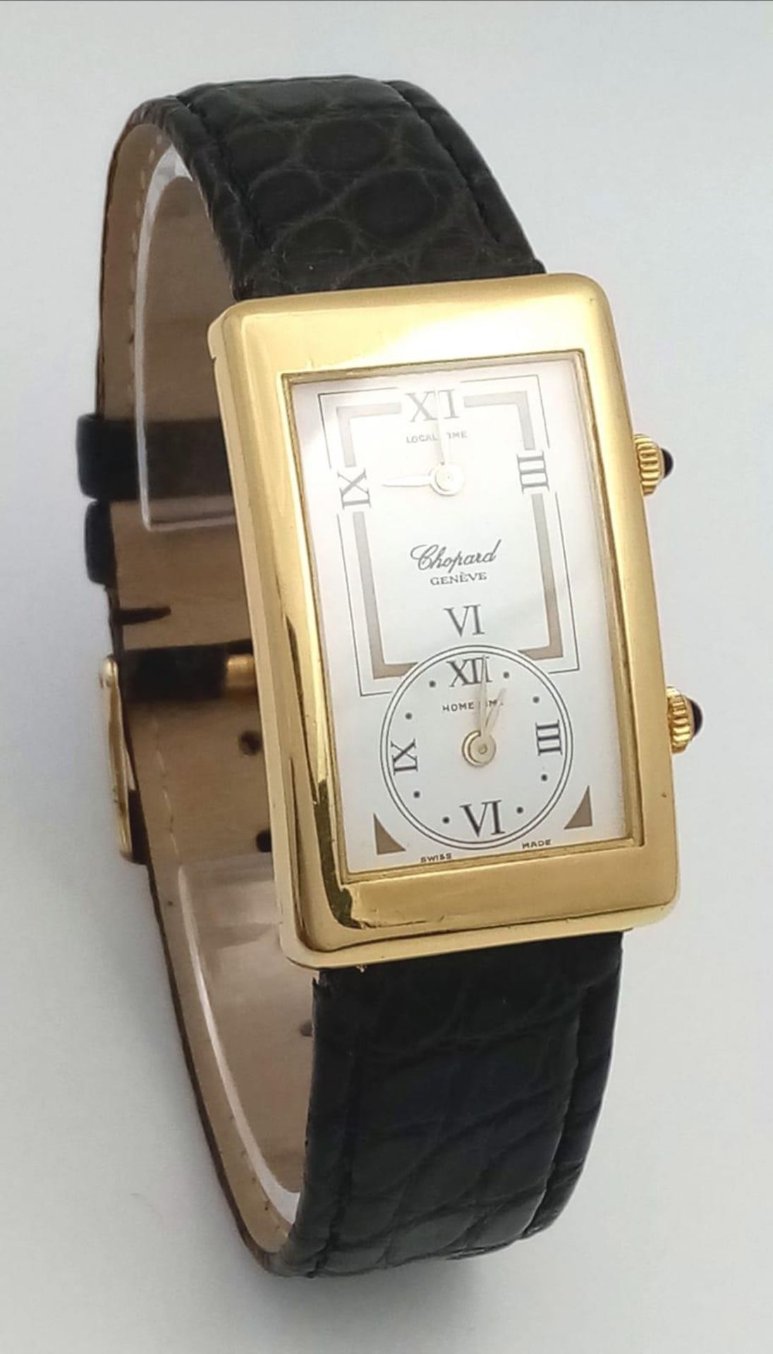 A Chopard 18K Gold Home Time (Dual Time) Gents Watch. Black leather strap. 18K gold rectangular case