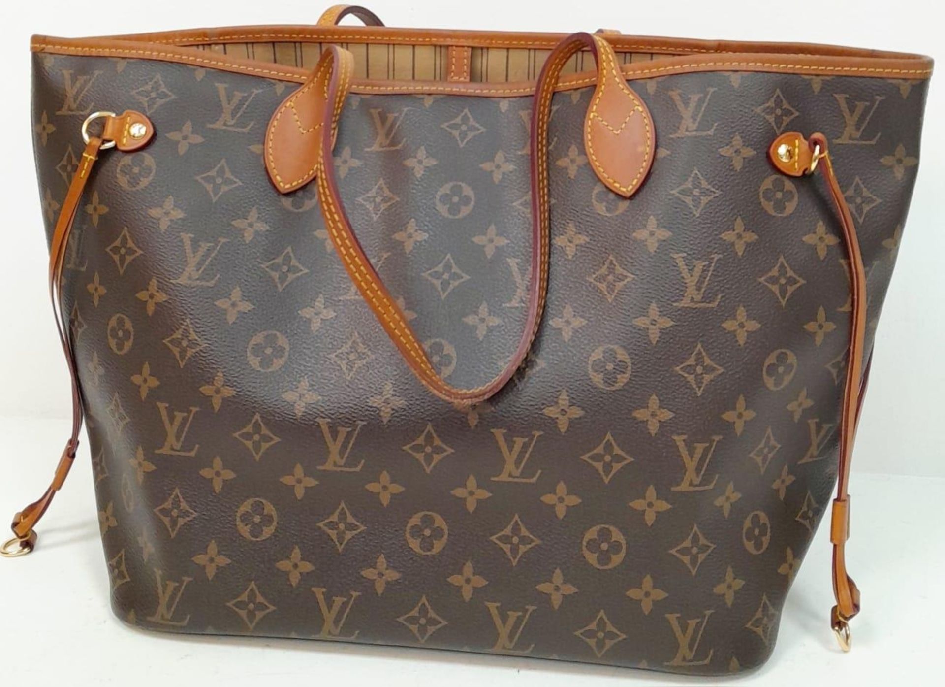 A Louis Vuitton Neverfull Tote Bag. LV monogram canvas exterior with cowhide handles and accents.