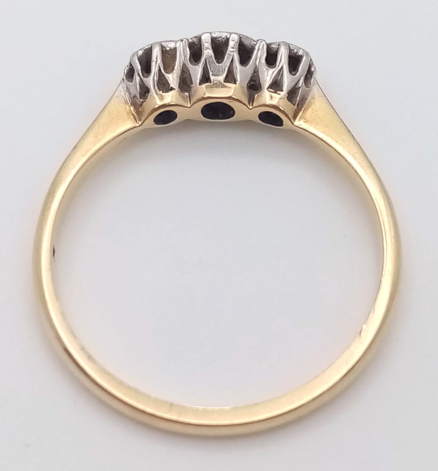 An 18 K yellow gold and platinum ring with a trilogy of round cut diamonds, size: L, weight: 1.9 g. - Image 3 of 4