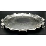 A 761gms solid silver Salva with scrolled edges and hand chased intricate decoration and