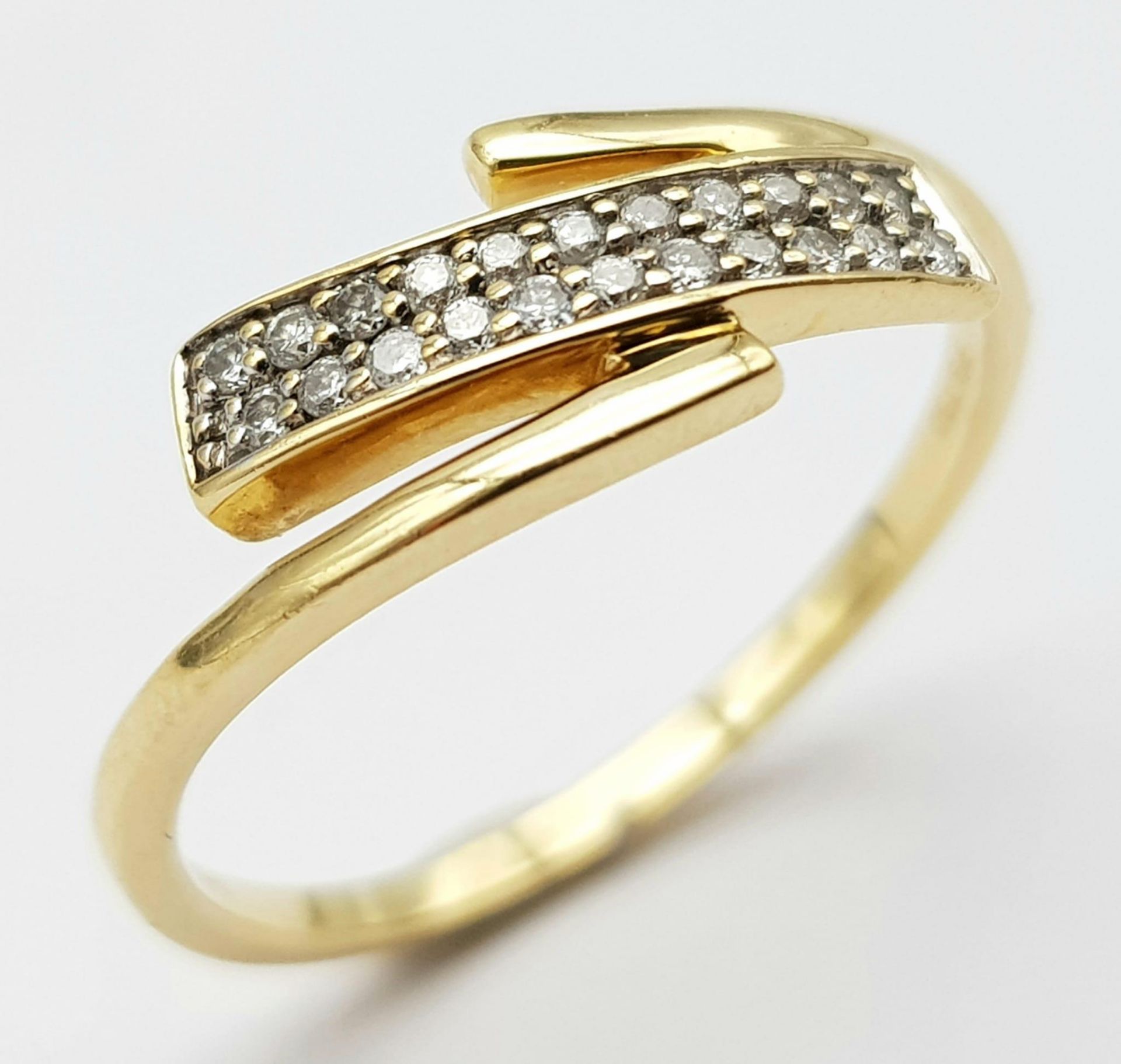 An 18K Yellow Gold Diamond 2 Row Crossover Ring. Size N, 2.2g total weight. Ref: 8461