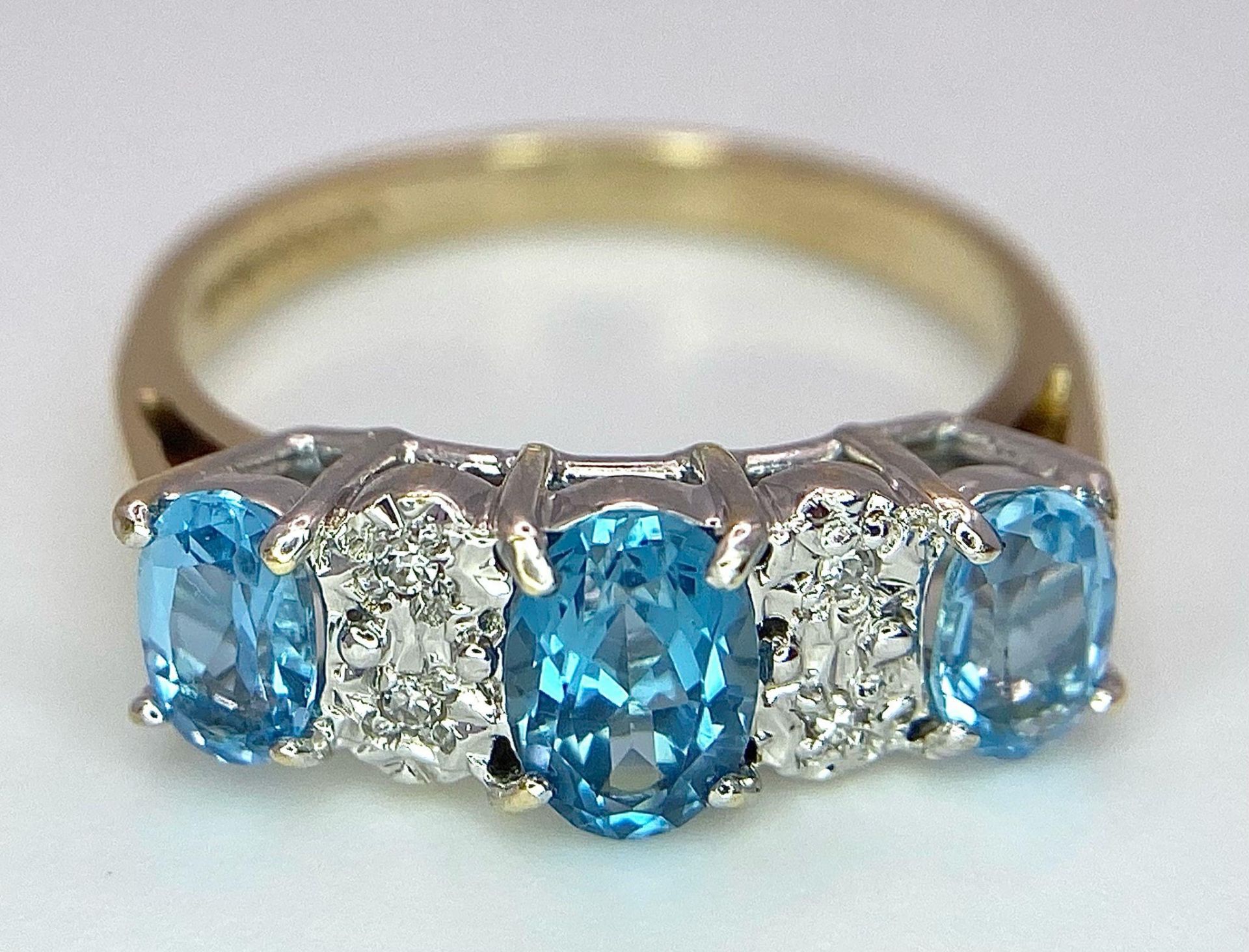 A 9K Yellow Gold Diamond and London Blue Topaz Ring. Size J, 2.1g total weight. Ref: 8410 - Image 4 of 6