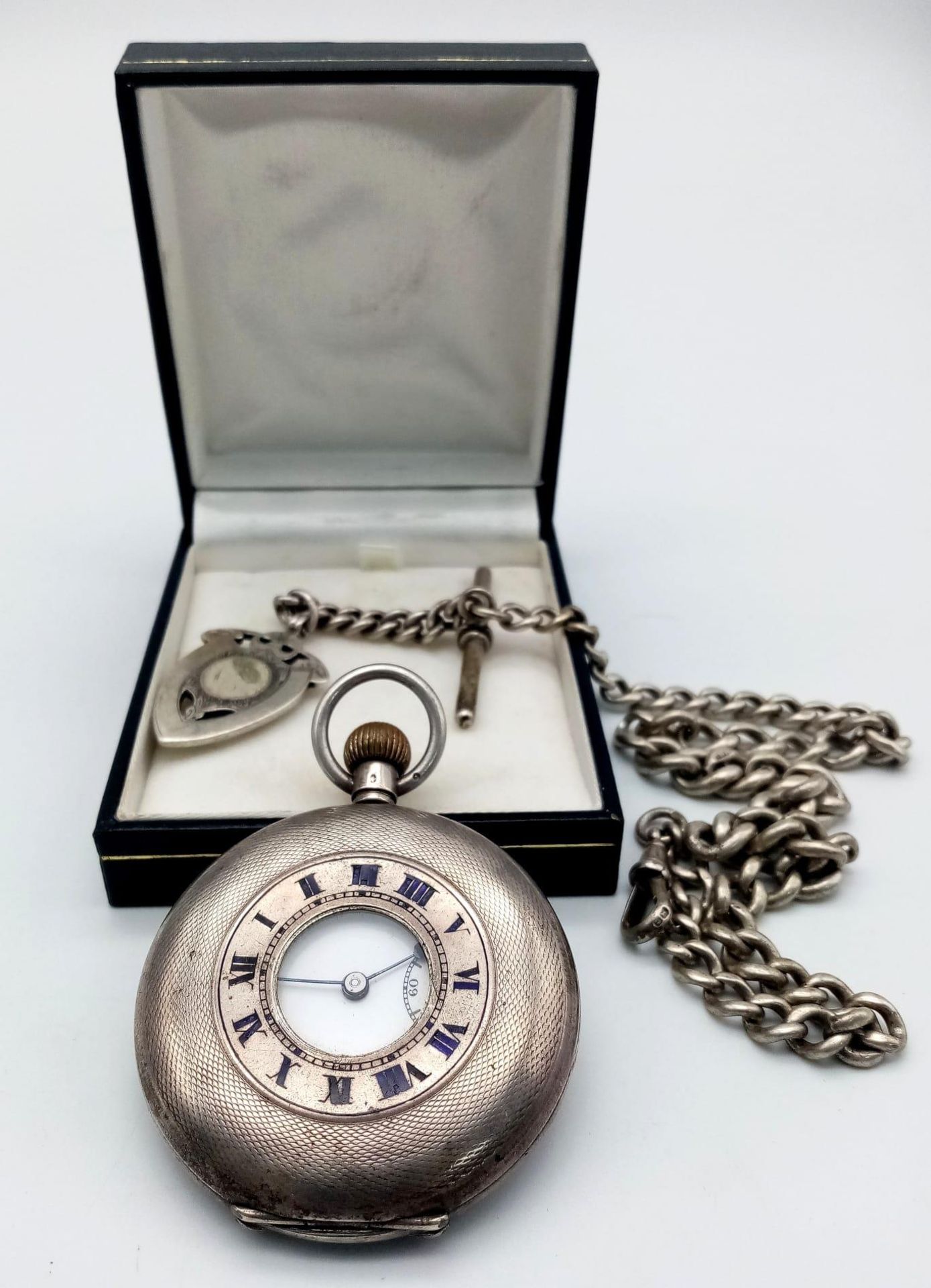 A Vintage Sterling Silver Half Hunter 'Record' Pocket Watch. Comes with an antique Albert chain