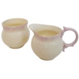A rare Irish Belleek sugar bowl and creamer. Cream colour with pink lips and gold ring on top,