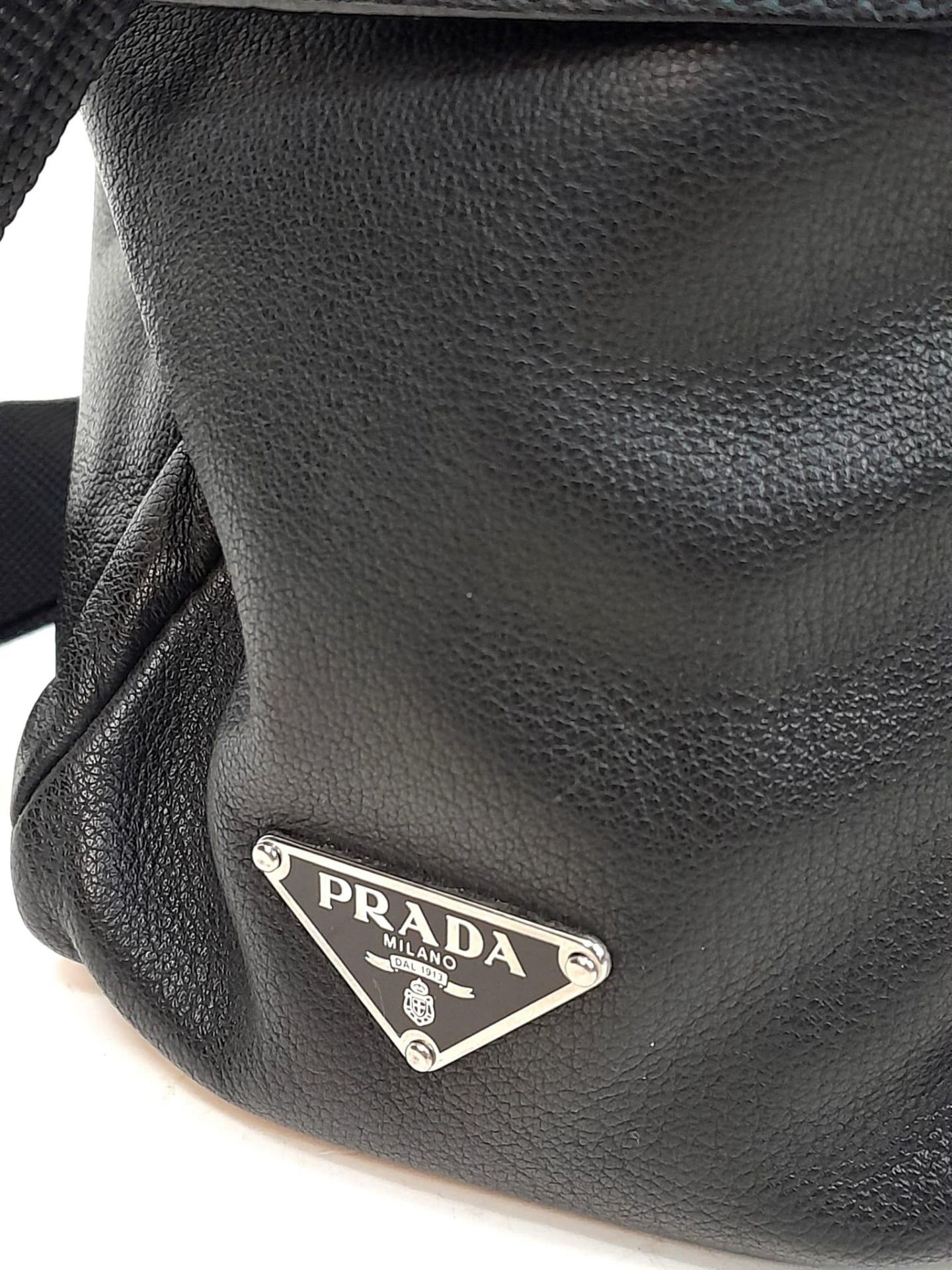 A Prada Black Duffle Bag. Leather exterior with silver-toned hardware, zipped outer compartment to - Image 7 of 12
