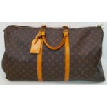 A Large Louis Vuitton Keepall Travel Bag. Monogram LV canvas exterior with cowhide leather handles