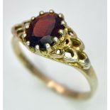 A 9K GOLD RING WITH GARNET CENTRE STONE . 2.1gms size O