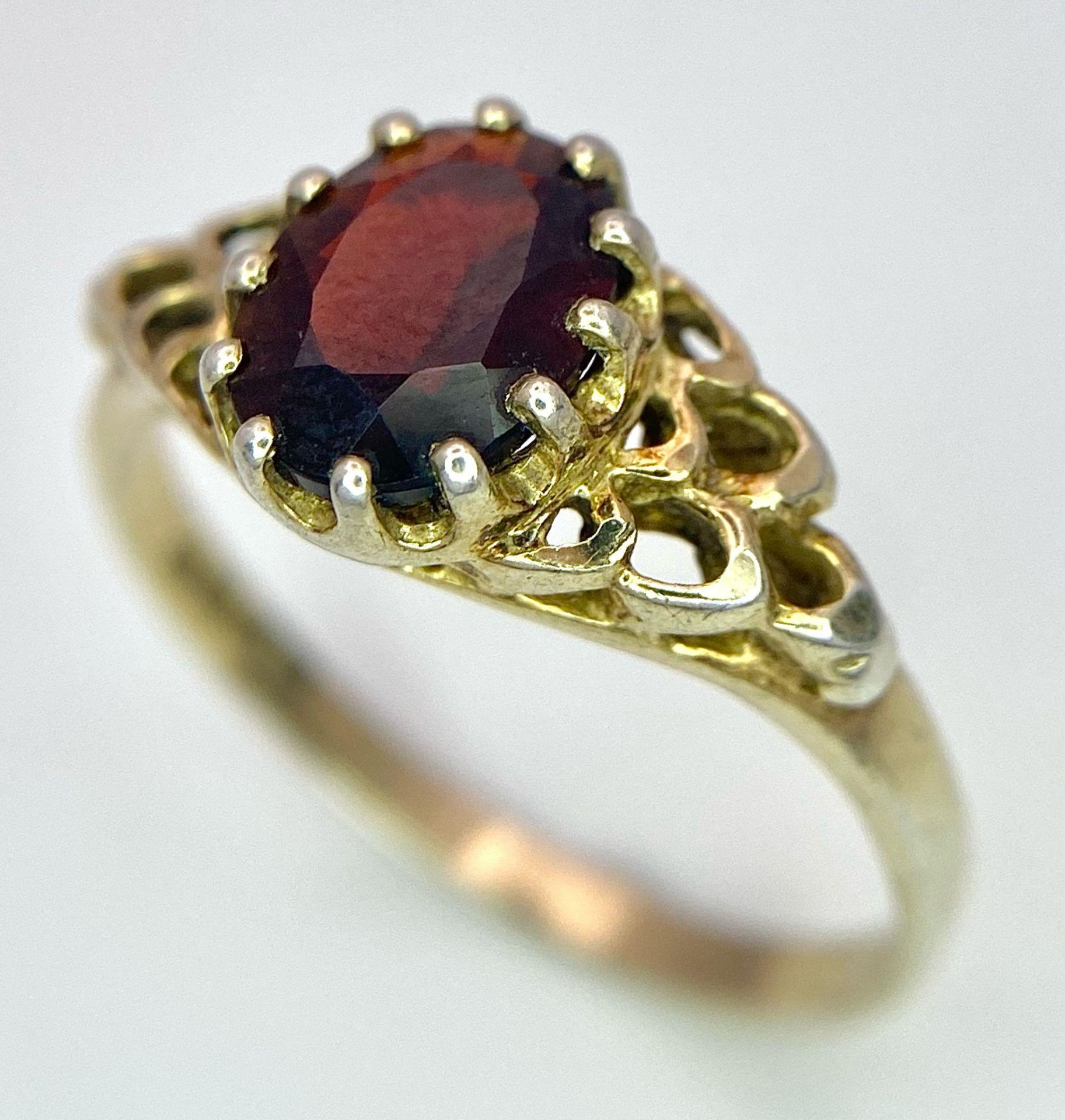 A 9K GOLD RING WITH GARNET CENTRE STONE . 2.1gms size O