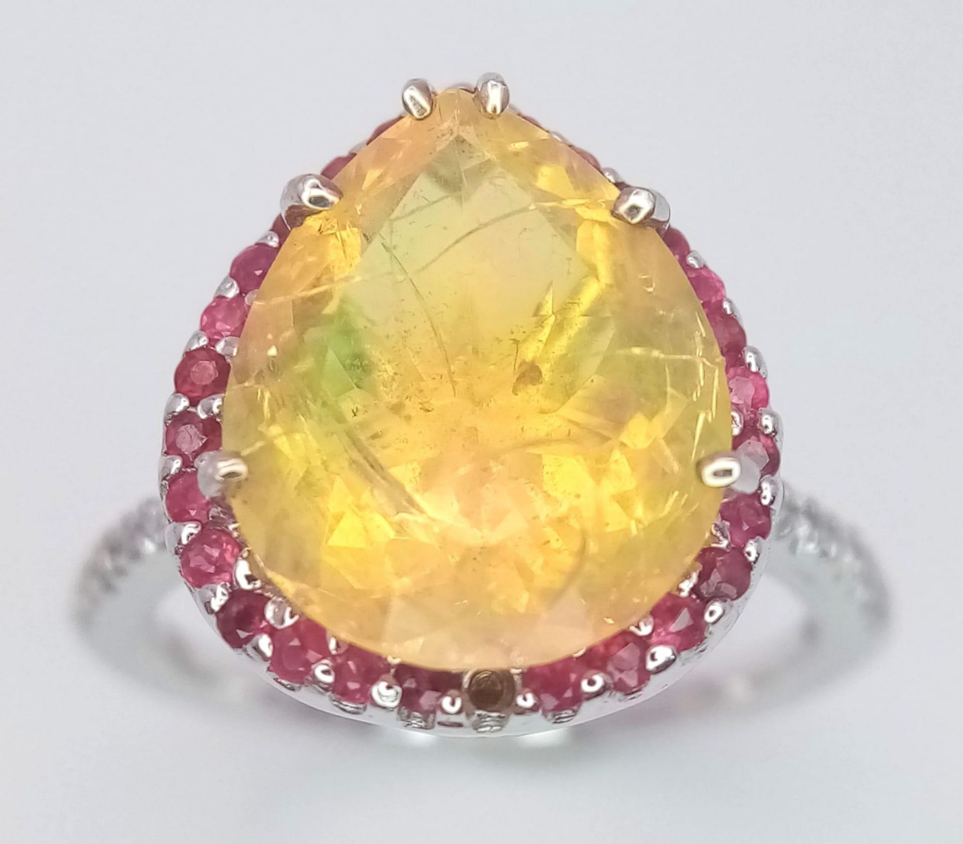 An 18 K white gold ring with a large, pear cut, fire opal exhibiting orange and green hues, - Image 2 of 9