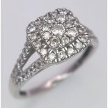 A 9 K white gold ring with a diamond cluster and more diamonds on the shoulders of the ring, size: