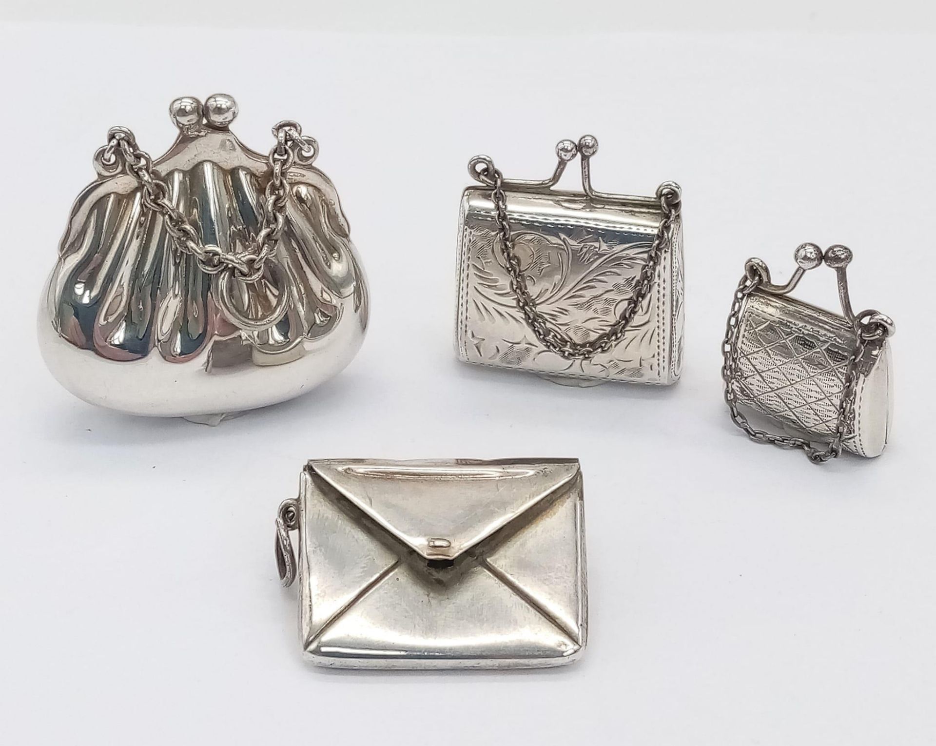 Four Sterling Silver Handbag Shaped Pendants. 40g total weight.