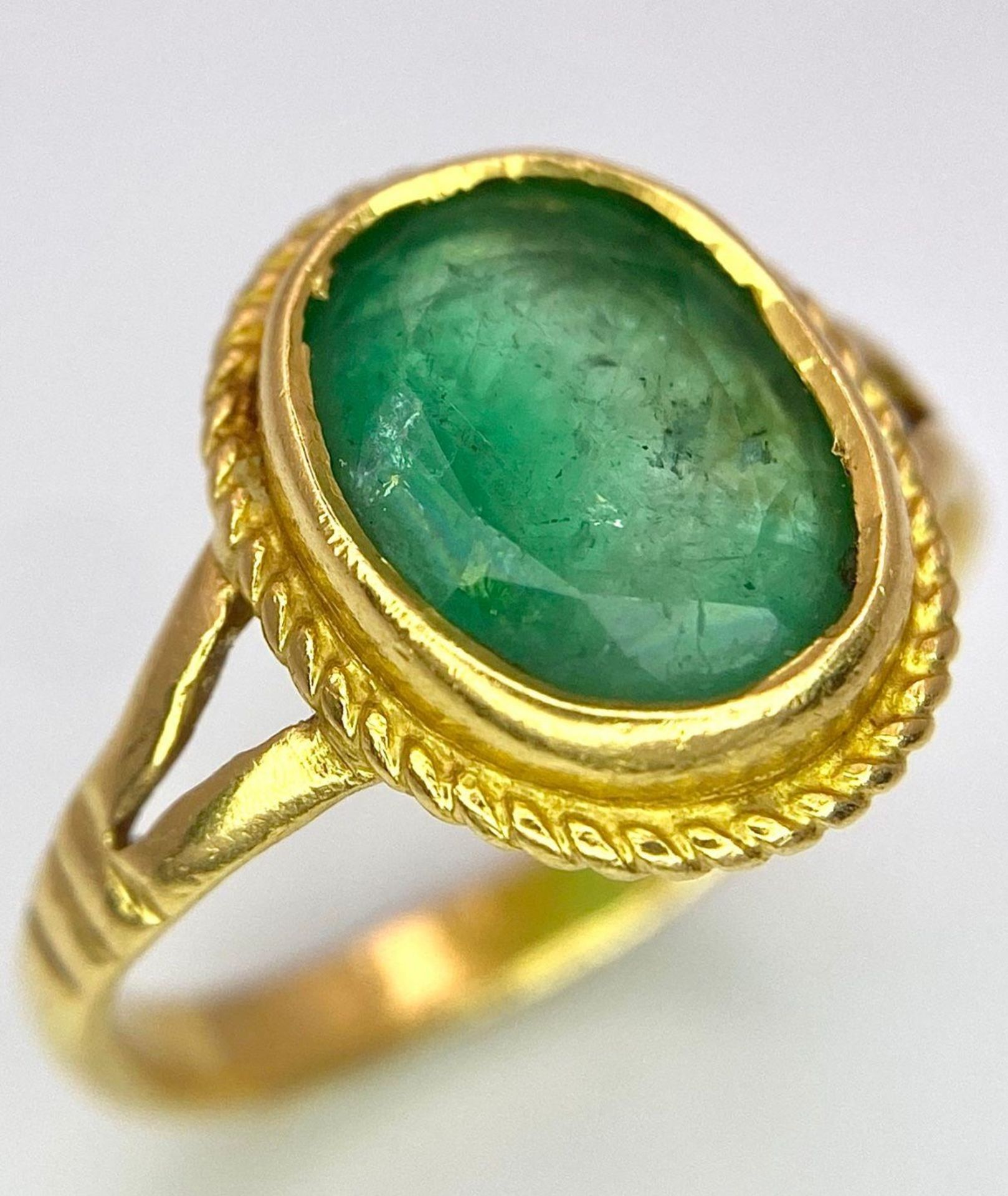 A 21K (tested) Green Emerald Ring. Central oval cut emerald. Size H. 3.15g weight. - Image 3 of 5
