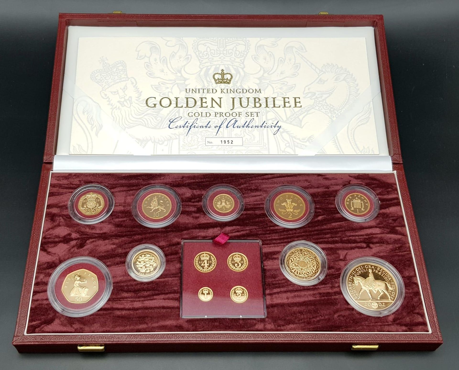 A Breathtaking Limited Edition 2002 Golden Jubilee 22K Gold Proof Coin Set. This set contains a