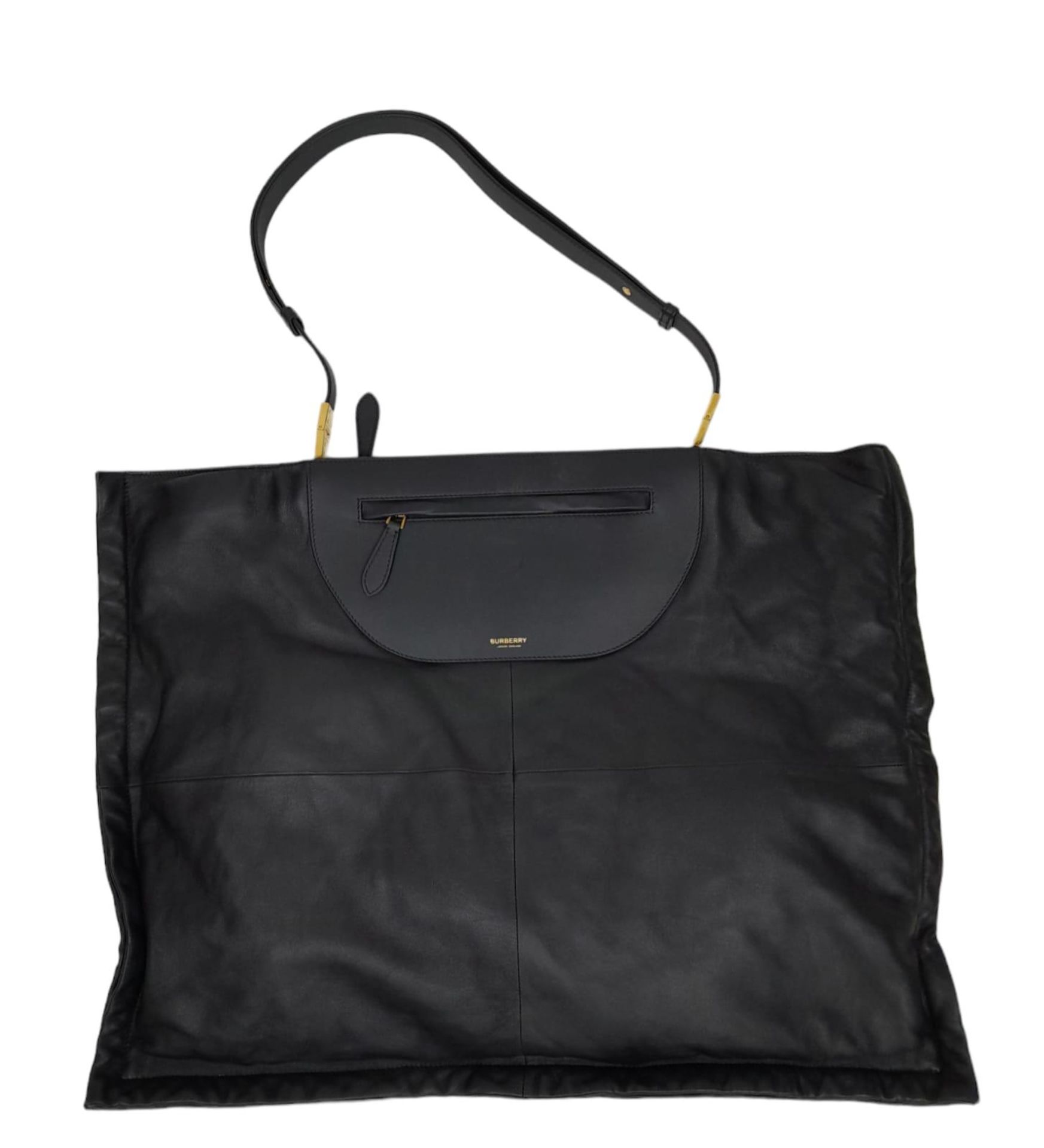 A Burberry Black Olympia Tote Bag. Soft leather exterior with gold-toned hardware, adjustable